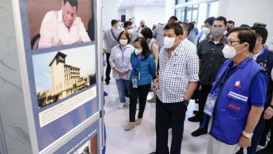 President Rodrigo Roa Duterte looks at the photos printed on the canvas while inspecting the ongoing construction of the Overseas Filipino Workers (OFW) Hospital at Barangay Sindalan in San Fernando City, Pampanga on May 1, 2022. RICHARD MADELO/ PRESIDENTIAL PHOTO